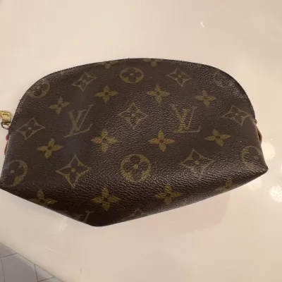Sale Photo Thumbnail #33: Louis Vuitton monogram canvas cosmetic pouch with a zippered top closure, showing some wear.