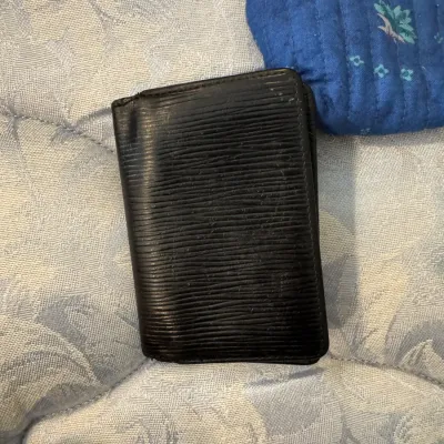 Sale Photo Thumbnail #170: Louis Vuitton black Epi leather card holder or small wallet, showing some wear on the edges and surface.