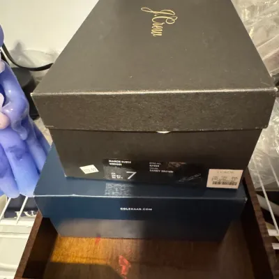 Sale Photo Thumbnail #175: Stack of two shoe boxes, featuring a black J.Crew box for "Marcie Suede Wedges" in size 7 on top of a blue Cole Haan box.