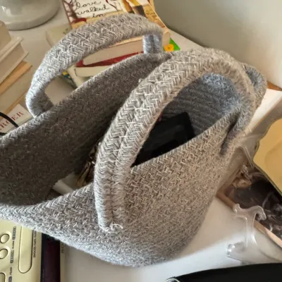Sale Photo Thumbnail #222: Small grey woven cotton rope basket with dual handles, suitable for tabletop storage or organization.