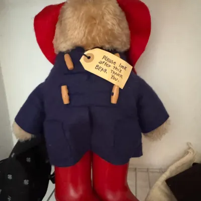 Sale Photo Thumbnail #164: Vintage Paddington Bear plush toy complete with a blue duffle coat, red bush hat, red rain boots, and his signature "Please look after this BEAR" tag.