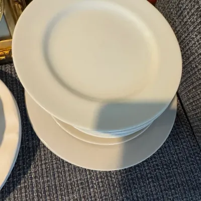 Sale Photo Thumbnail #298: Stack of simple white ceramic plates in clean condition, suitable for everyday dining.