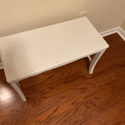 Sale Photo Thumbnail #138: White painted wooden bench or small table with curved cabriole legs, showing some surface wear and scratches.