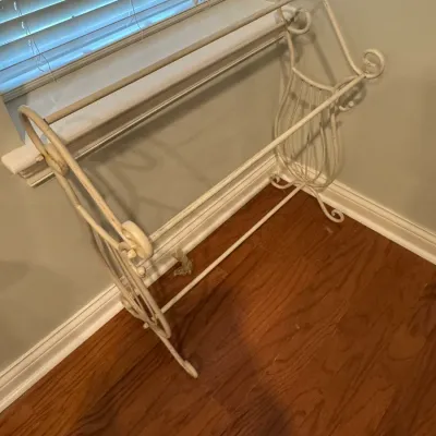 Sale Photo Thumbnail #35: Vintage white-painted wrought iron quilt rack featuring scrollwork details and a lyre-shaped base design.