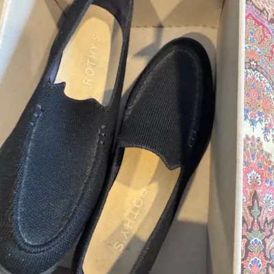 Sale Photo Thumbnail #45: Pair of black Rothy's slip-on loafer shoes in their original box, showing light wear.