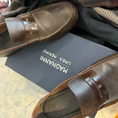 Sale Photo Thumbnail #173: Pair of Magnanni Linea Merino brown leather penny loafers, showing light wear, displayed with their original blue shoebox.