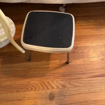 Sale Photo Thumbnail #214: Vintage Cosco step stool with a white metal frame, chrome legs, and a black ribbed rubber tread top.