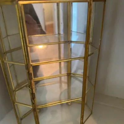 Sale Photo Thumbnail #186: Vintage brass and glass hexagonal curio display cabinet with three interior shelves and a mirrored back.