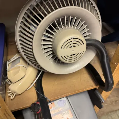 Sale Photo Thumbnail #81: Vintage Vornado beige plastic air circulator fan with a black metal stand, shown alongside a vintage beige landline telephone.