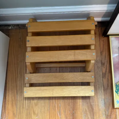 Sale Photo Thumbnail #236: Small wooden two-step stool with a natural finish, featuring slatted steps and visible screw construction.