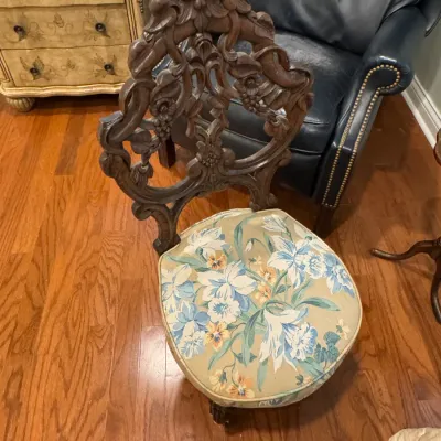 Sale Photo Thumbnail #37: Victorian-style side chair featuring an intricately carved openwork wooden back and a padded seat upholstered in a blue and white floral fabric.