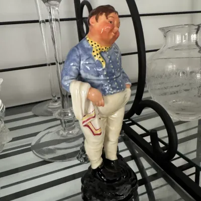 Sale Photo Thumbnail #350: Vintage Royal Doulton porcelain figurine depicting 'The Foaming Quart' character HN 2162, featuring a man in a blue jacket and yellow cravat.