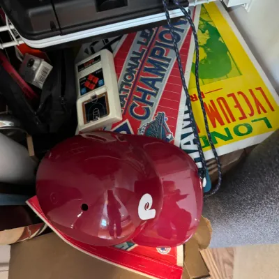 Sale Photo Thumbnail #44: Vintage Philadelphia Phillies souvenir batting helmet and 1993 National League Champions pennant, displayed alongside other retro memorabilia.