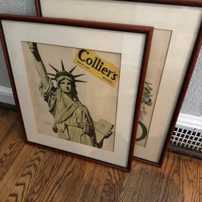 Sale Photo Thumbnail #244: Framed vintage Collier's magazine cover from June 27, 1942, featuring the Statue of Liberty, alongside another framed print in matching wooden frames.