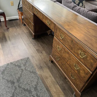 Sale Photo Thumbnail #335: Vintage Chippendale-style mahogany partner's desk or double-pedestal desk featuring ornate brass batwing drawer pulls and bracket feet.