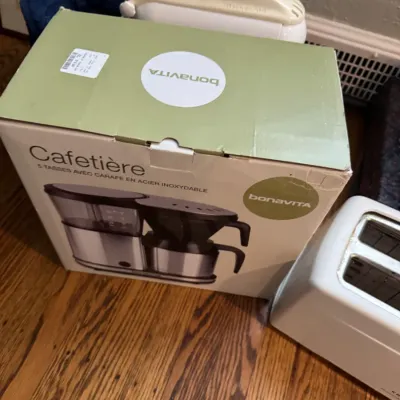 Sale Photo Thumbnail #241: Bonavita 5-cup coffee maker with stainless steel carafe, new in its original box, shown alongside other small kitchen appliances.