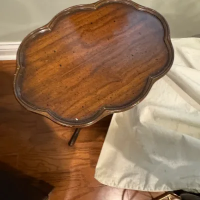 Sale Photo Thumbnail #23: Vintage wooden accent table featuring a scalloped, tray-style top with a rich, polished grain finish.