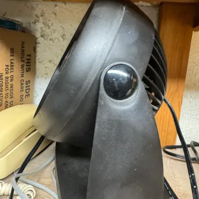 Sale Photo Thumbnail #100: Vornado black plastic personal air circulator fan, showing some surface dust from storage.
