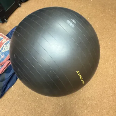 Sale Photo Thumbnail #114: Definity black exercise stability ball with ribbed texture, showing light surface wear.