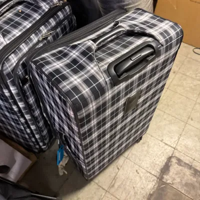 Sale Photo Thumbnail #77: Two matching black and white plaid rolling suitcases with telescoping handles, showing light wear.