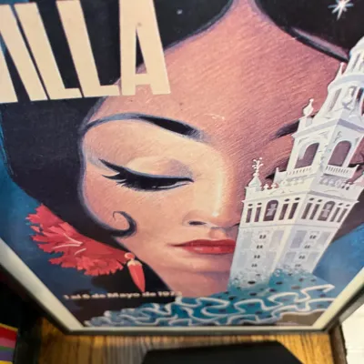 Sale Photo Thumbnail #55: Framed vintage Spanish travel poster featuring a stylized illustration of a woman and a white tower, dated May 1973.