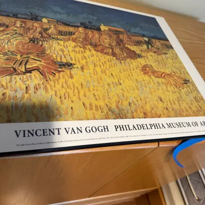 Sale Photo Thumbnail #176: Vincent van Gogh exhibition poster from the Philadelphia Museum of Art, featuring the painting "Harvest in Provence," dated 2000-2001.