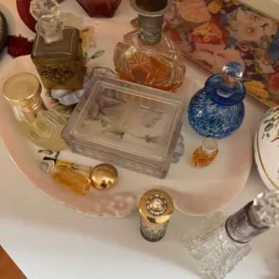 Sale Photo Thumbnail #49: Collection of vintage perfume bottles and a glass vanity box displayed on a floral porcelain tray.