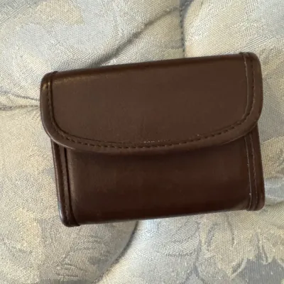 Sale Photo Thumbnail #171: Vintage Coach dark brown leather trifold wallet, showing minor wear on the edges.