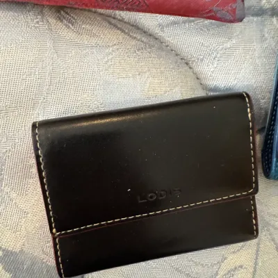 Sale Photo Thumbnail #168: Lodis black leather trifold wallet with contrast stitching and embossed logo.