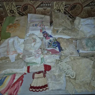 Sale Photo Thumbnail #7: Large assortment of vintage linens, including embroidered handkerchiefs, crocheted doilies, lace trims, and hand-stitched potholders.
