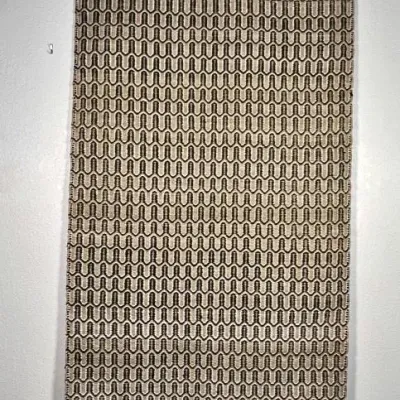 Sale Photo Thumbnail #13: Woven textile wall hanging or runner featuring a repeating geometric pattern in neutral cream and brown tones, suspended from two black hangers.