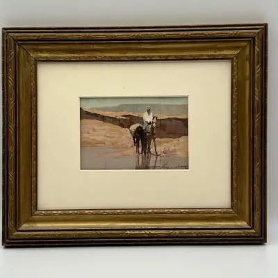 Sale Photo Thumbnail #5: Framed Western watercolor painting depicting a rider on horseback with a pack horse, signed by the artist, housed in a carved giltwood frame.