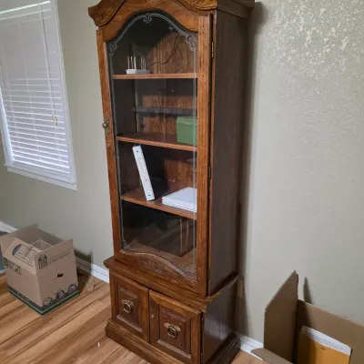 Sale Photo Thumbnail #7: Vintage oak curio cabinet featuring a bonnet top, etched glass door, interior shelving, and a lower two-door storage cabinet with brass ring pulls.