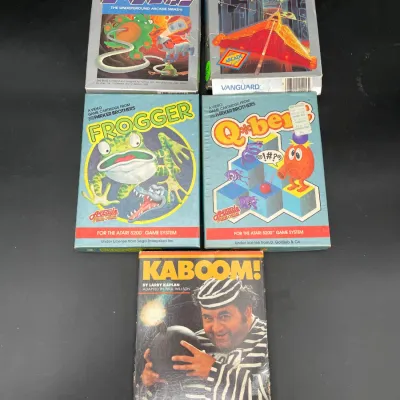 Collection of five vintage Atari 5200 video games in their original boxes, including Dig Dug, Vanguard, Frogger, Q*bert, and Kaboom!.
