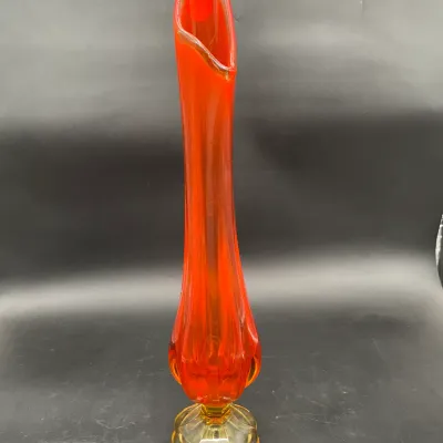 Mid-century modern Viking glass swung vase in vibrant persimmon orange with a yellow-amber pedestal base.