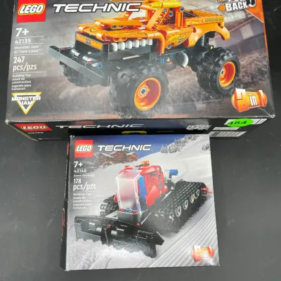 Two boxed Lego Technic sets, including Monster Jam El Toro Loco (42135) and Snow Groomer (42148).
