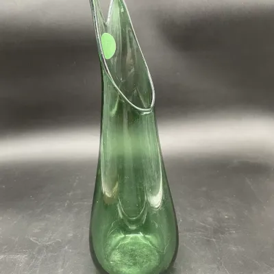 Mid-century modern green art glass vase featuring an asymmetrical, pulled rim and a teardrop-shaped body.