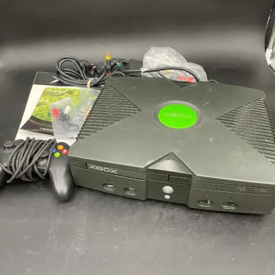 Original Microsoft Xbox console bundle, including a Controller S, AV cables, power cord, and user manual.