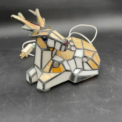 Vintage Tiffany-style stained glass deer accent lamp, featuring a reclining buck with amber and white glass panels.