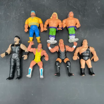 Collection of vintage WWF Hasbro action figures from the early 1990s, featuring wrestlers like Hulk Hogan, Andre the Giant, and Ted DiBiase.