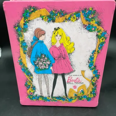 Vintage 1968 Mattel "The World of Barbie" vinyl doll trunk in pink, featuring illustrated graphics of Barbie and PJ on the...