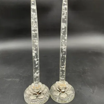 Pair of vintage mid-century clear acrylic taper candles embedded with silver foil flakes, set in matching floral-motif glass bases.