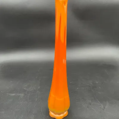 Mid-century modern Viking glass swung vase in a vibrant orange persimmon hue, featuring a classic six-petal base and a delicate pulled rim.