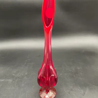 Viking Glass ruby red swung vase in the 'Epic Six Petal' pattern, featuring a tall, slender neck and a footed base with the...