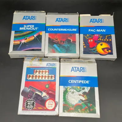 Collection of five vintage Atari 5200 video game cartridges in their original boxes, including Super Breakout, Countermeasure, Pac-Man,...
