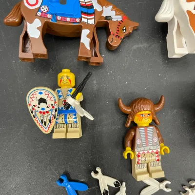 Vintage Lego Western Indian minifigures and decorated horse from the late 1990s, complete with a shield, headdress, and feather accessories.
