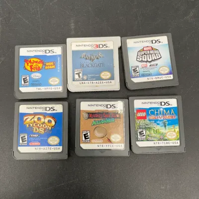 Collection of six Nintendo DS and 3DS game cartridges, including titles like Zoo Tycoon DS, Batman Arkham Origins Blackgate, and Marvel...