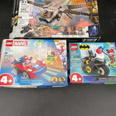 Three unopened LEGO superhero sets, including Marvel's Black Panther Dragon Flyer (76186), Spider-Man's Car and Doc Ock...
