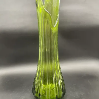 Mid-century modern green swung glass vase featuring a ribbed texture and a flared, asymmetrical rim.