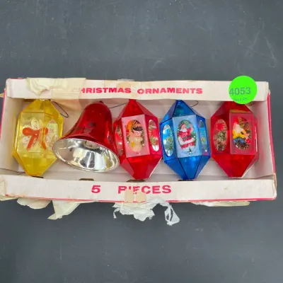 Vintage set of five plastic Christmas ornaments in their original box, featuring colorful diorama lanterns and a red bell, circa 1960s.